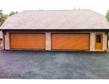 Double Roller Shutter Garage Doors with a matching wood finish.