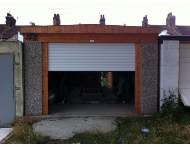 The garage door includes a patented locking system and rolling code remote control technology.